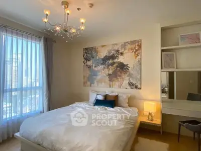 Elegant bedroom with modern chandelier and large window view