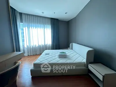 Modern bedroom with stylish bed and natural light through large window