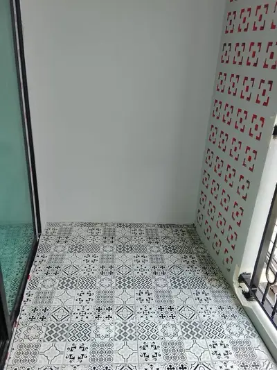 Charming balcony with decorative tiles and modern railing, perfect for relaxation.