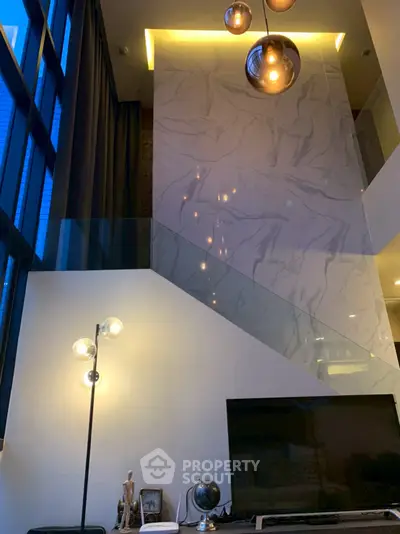 Luxurious modern living room with high ceilings and elegant lighting