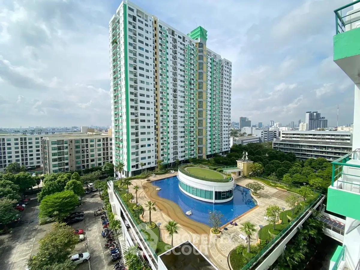 Stunning high-rise building with pool and lush garden offering panoramic city views.