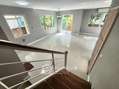 Spacious modern living room with large windows and garden view