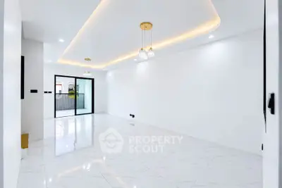 Spacious modern living room with elegant lighting and glossy white flooring