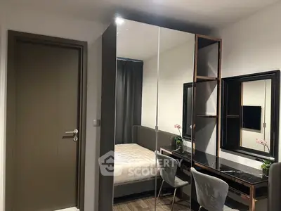Modern bedroom with stylish mirrored wardrobe and elegant vanity desk