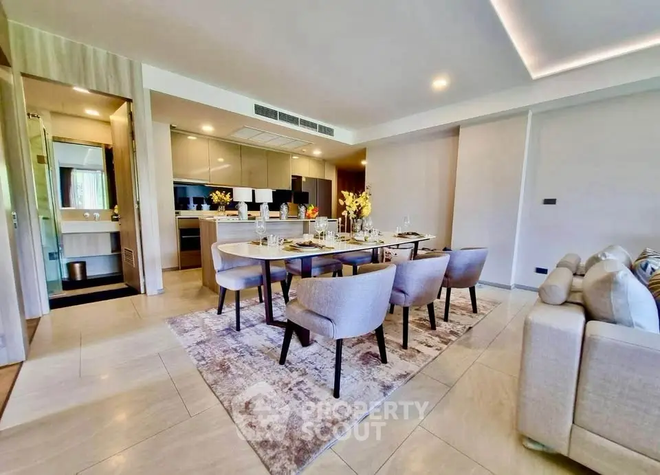 Luxurious open-plan living and dining area with modern kitchen and elegant decor.