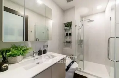 Modern bathroom with sleek shower and elegant vanity in contemporary home.