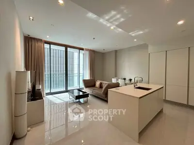 Modern open-layout living room with sleek kitchen island and large windows.