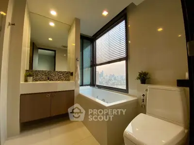 Luxurious bathroom with city view, featuring a modern bathtub and elegant fixtures.