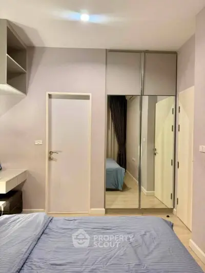 Modern bedroom with mirrored closet and sleek design