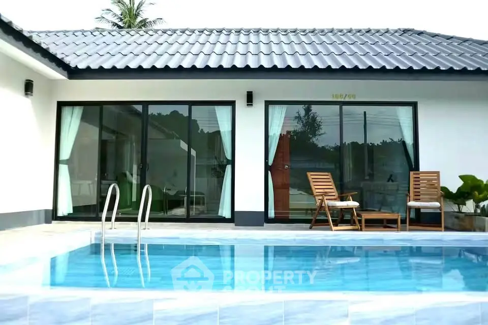 Stunning modern villa with private pool and elegant patio seating, perfect for luxury living.