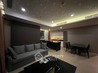 Luxurious modern living room with open kitchen and starry ceiling lights