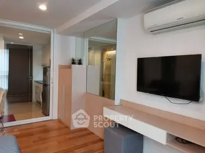 Modern living room with sleek design, featuring a wall-mounted TV and air conditioning, perfect for urban living.