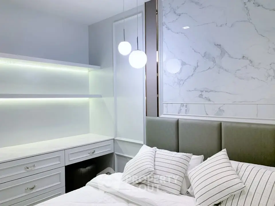 Modern bedroom with elegant marble accent wall and stylish lighting