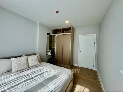 Modern bedroom with stylish decor and ample natural light