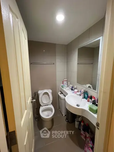 Compact bathroom with modern fixtures and ample storage space.