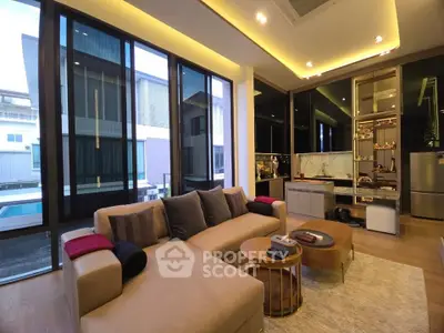 Luxurious modern living room with floor-to-ceiling windows and stylish furniture in a contemporary home.