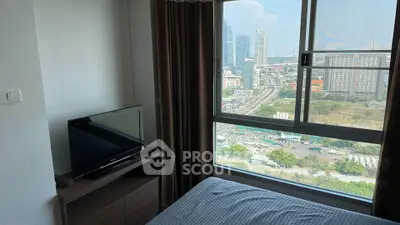 Modern bedroom with city view, featuring a large window and sleek furniture.