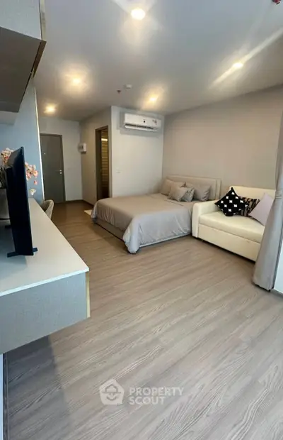 Modern studio apartment with cozy bed and stylish decor