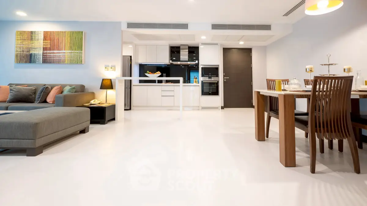 Modern open-plan living room and kitchen with stylish furniture and decor