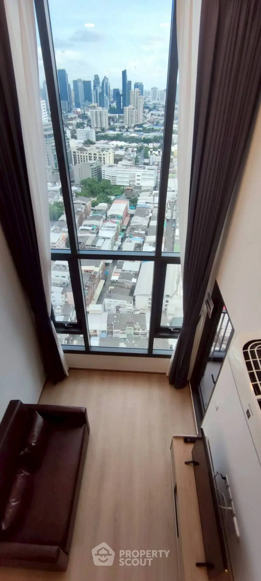 Stunning high-rise apartment with floor-to-ceiling windows offering breathtaking city views.