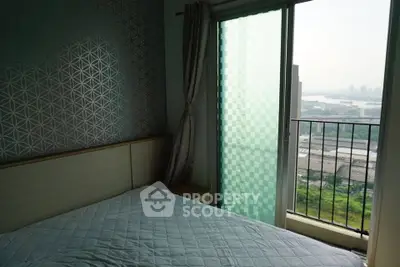Cozy bedroom with balcony offering stunning city and river views, perfect for relaxation and comfort.