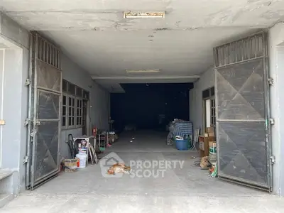 Spacious garage with open doors and storage potential