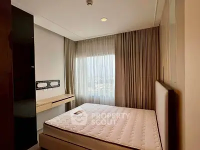 Modern bedroom with large window and elegant curtains, featuring a comfortable bed and sleek design.