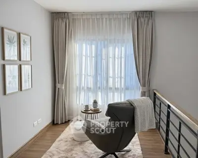 Cozy reading nook with plush chair and elegant curtains in modern home