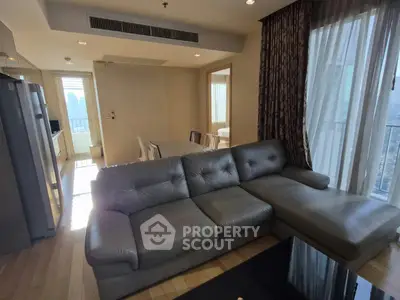 Spacious modern living room with large sofa and natural light