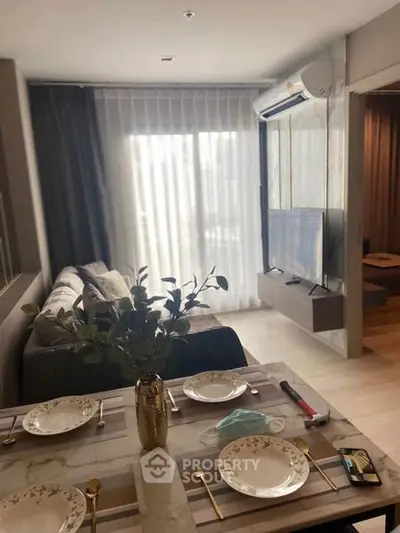 Modern living room with elegant dining setup and large window view