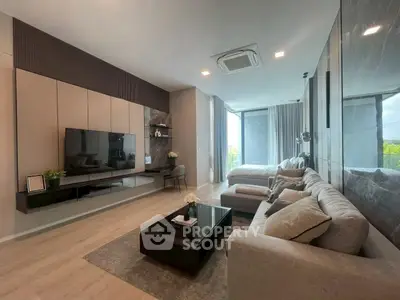 Luxurious modern living room with sleek design and large windows offering natural light.