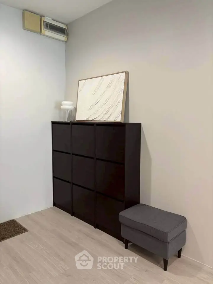 Modern minimalist interior with sleek storage cabinet and stylish decor