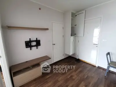 Minimalist room with wall-mounted TV bracket and wooden flooring, perfect for modern living.