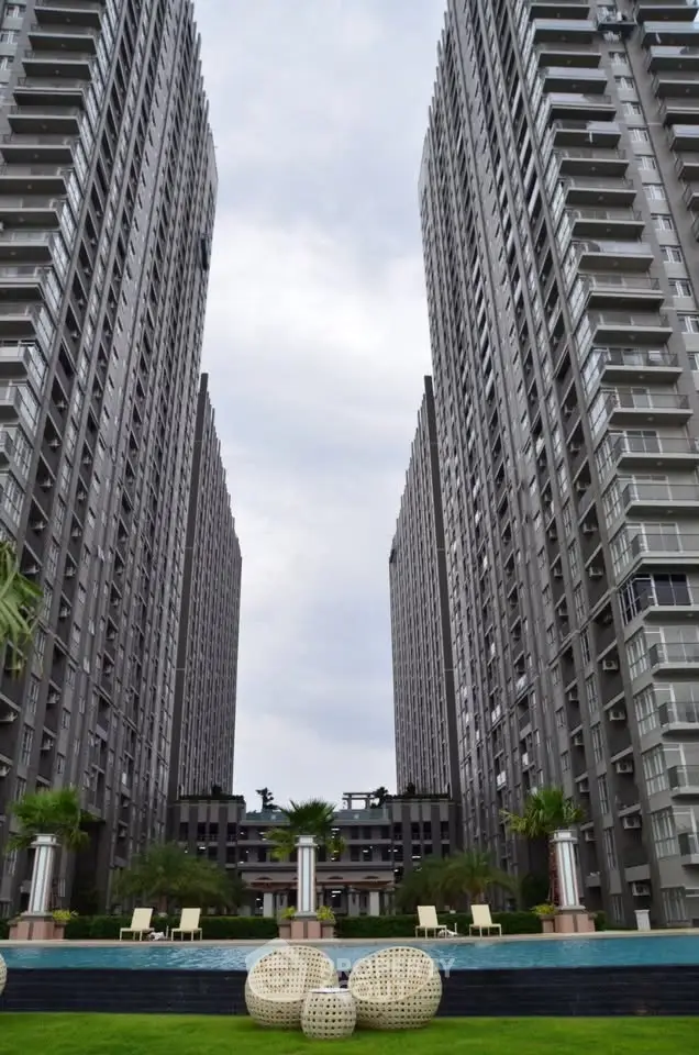 Stunning high-rise residential buildings with lush garden and pool area, offering modern urban living.