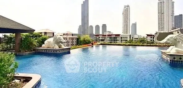 Luxurious rooftop pool with stunning city skyline views and elegant sculptures.
