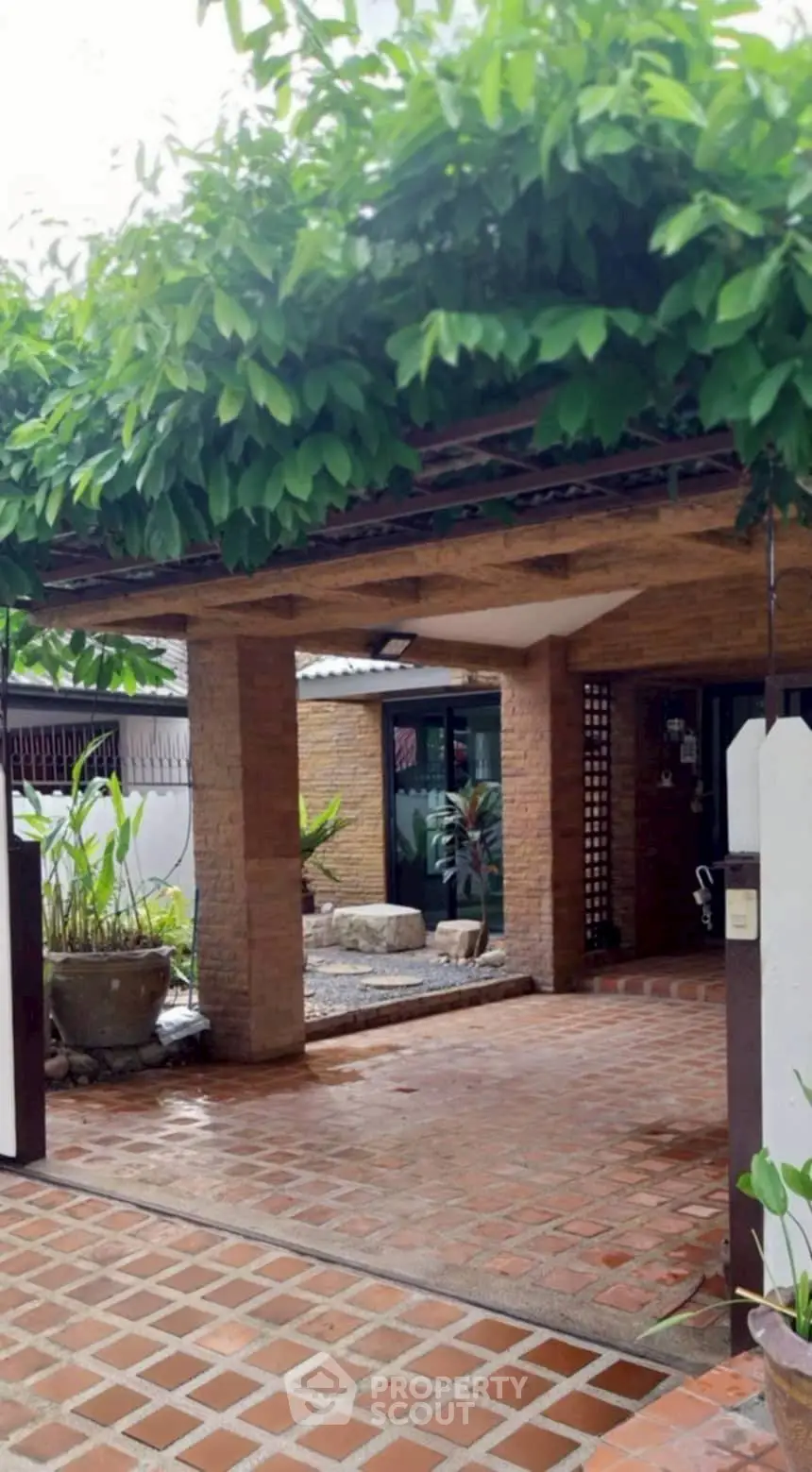 Charming brick exterior with lush greenery and inviting entrance