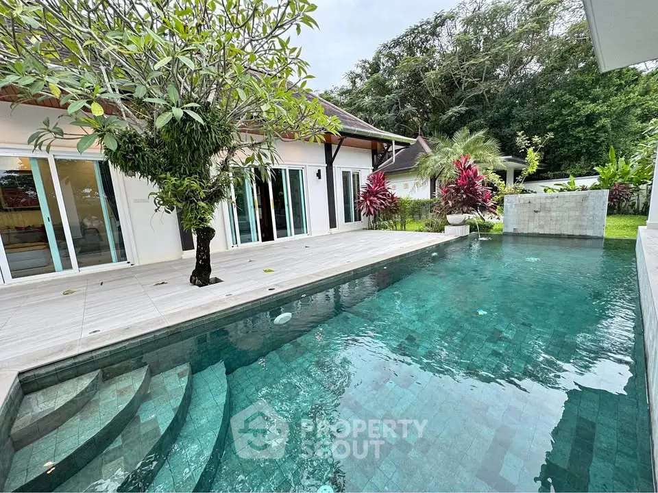 Luxurious villa with private pool and lush garden, perfect for tropical living.