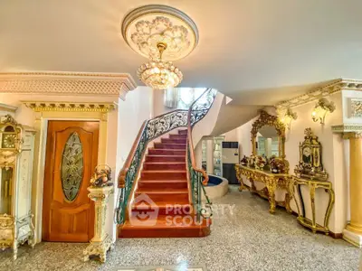 Luxurious interior with ornate staircase and elegant decor, showcasing opulent real estate design.