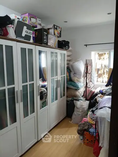 Spacious storage room with ample closet space and natural light, ideal for organized living.