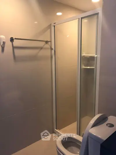 Modern bathroom with glass shower enclosure and sleek fixtures
