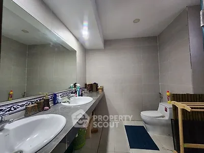 Spacious bathroom with dual sinks and modern fixtures in a stylish home.