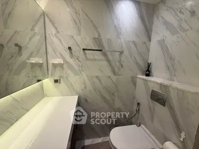 Luxurious marble bathroom with modern fixtures and ambient lighting