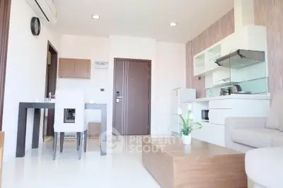 Modern living room with sleek furniture and open kitchen layout
