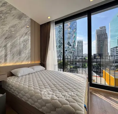 Luxurious bedroom with stunning city view and modern design in high-rise apartment.