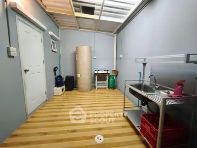 Functional storage room with sink and wooden flooring