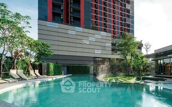 Luxurious residential building with a stunning outdoor pool and lush greenery, perfect for relaxation.