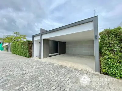 Modern minimalist garage with sleek design and spacious driveway