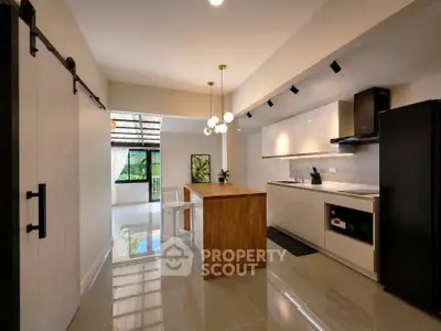 Modern kitchen with sleek design, featuring an island and open layout, perfect for entertaining.