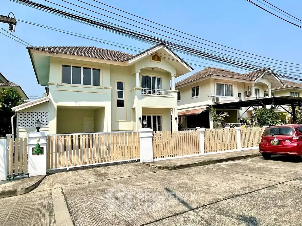 Charming suburban home with spacious driveway and modern architecture.