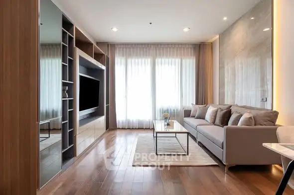 Modern living room with elegant decor and large windows for natural light.